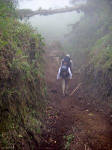 Rear view of Anna hiking the shit tunnel in Costa Rica